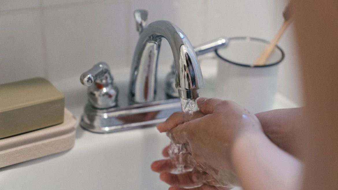 Дитячі руки під краном з водою